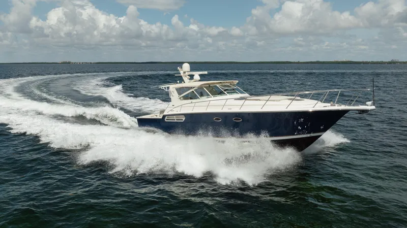  Yacht Photos Pics 1998 Tiara Yachts 4300 Open cruising on open water under a partly cloudy sky.