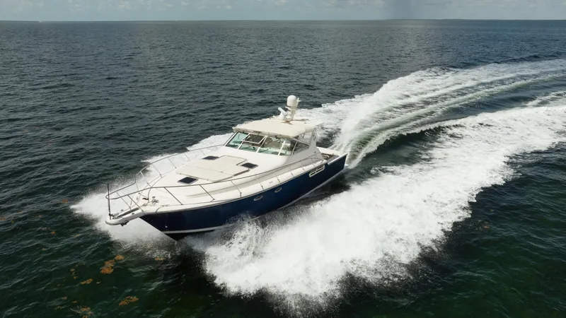  Yacht Photos Pics 1998 Tiara Yachts 4300 Open cruising on open water, creating a dynamic wake.
