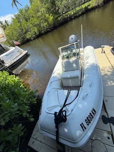  Yacht Photos Pics White inflatable boat docked beside a Tiara Yachts 4300 Open, 1998 model, on a sunny day.