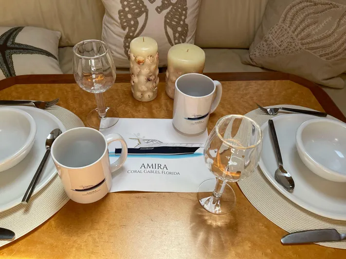  Yacht Photos Pics Elegant dining setup on 1998 Tiara Yachts 4300 Open, featuring mugs and wine glasses.