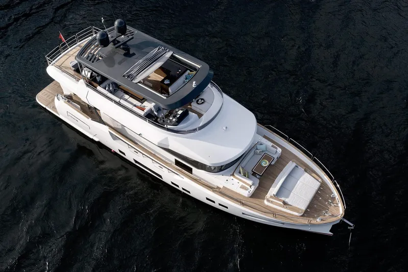  Yacht Photos Pics Luxurious 2022 Sirena 68 yacht cruising on open water, aerial view.