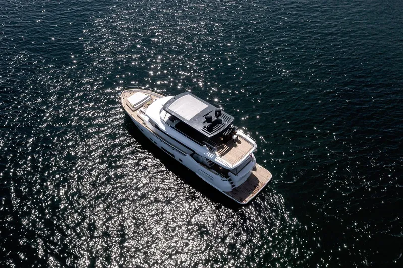  Yacht Photos Pics Luxurious 2022 Sirena 68 yacht cruising on sparkling water.