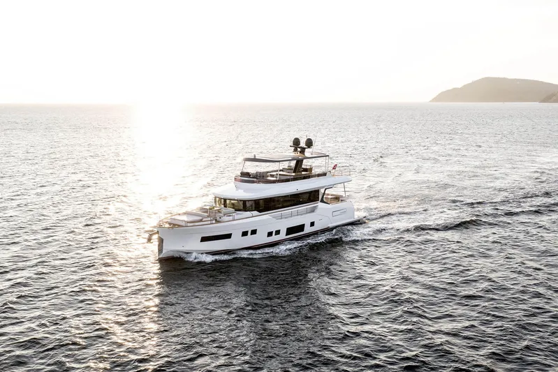  Yacht Photos Pics 2022 Sirena 68 yacht cruising at sunset on open sea.