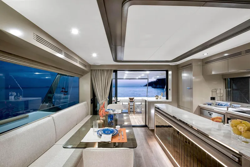  Yacht Photos Pics Luxurious interior of 2022 Sirena 68 yacht with elegant dining area and ocean view.