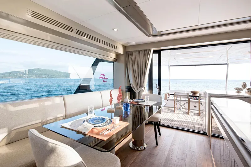  Yacht Photos Pics Luxurious interior of 2022 Sirena 68 yacht with ocean view and elegant dining area.