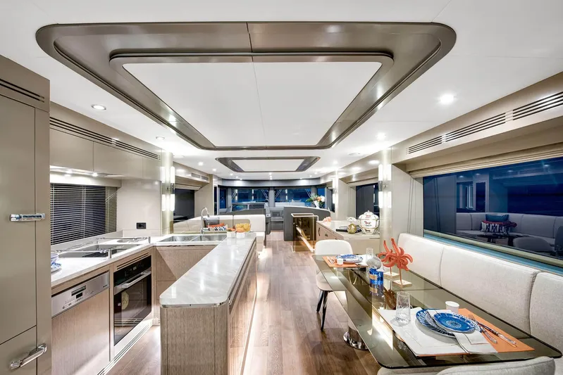 Yacht Photos Pics Luxurious interior of 2022 Sirena 68 yacht with modern kitchen and dining area.