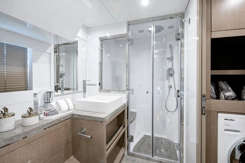  Yacht Photos Pics Luxurious bathroom in 2022 Sirena 68 yacht with modern shower and elegant fixtures.