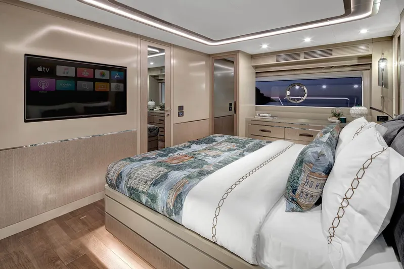  Yacht Photos Pics Luxurious bedroom interior of 2022 Sirena 68 yacht with modern decor and large TV.