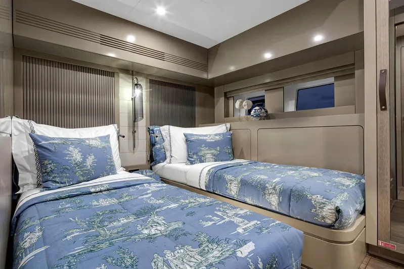  Yacht Photos Pics Luxurious twin bedroom in 2022 Sirena 68 yacht with elegant blue bedding.