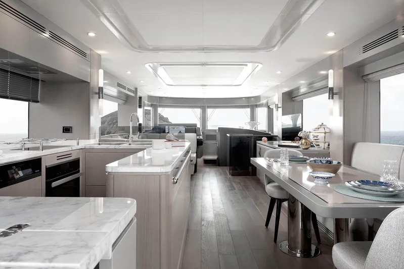  Yacht Photos Pics Luxurious interior of 2022 Sirena 68 yacht with modern kitchen and dining area.