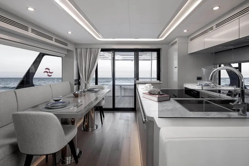  Yacht Photos Pics Luxurious interior of 2022 Sirena 68 yacht with modern kitchen and dining area.