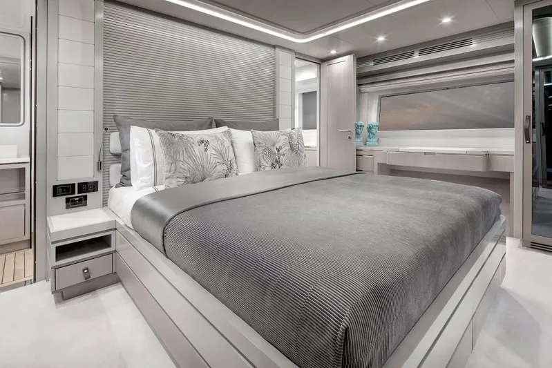  Yacht Photos Pics Luxurious bedroom interior of 2022 Sirena 68 yacht with modern design and elegant decor.