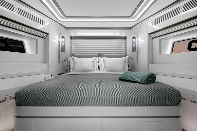  Yacht Photos Pics Luxurious bedroom interior of 2022 Sirena 68 yacht with modern design and elegant bedding.