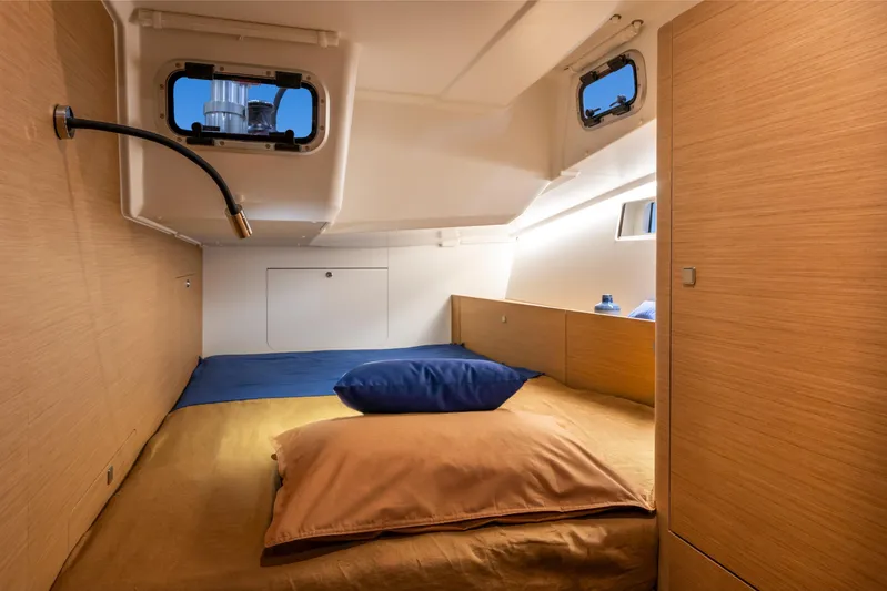  Yacht Photos Pics Cozy cabin interior of 2026 Jeanneau Sun Odyssey 455 sailboat with modern design.