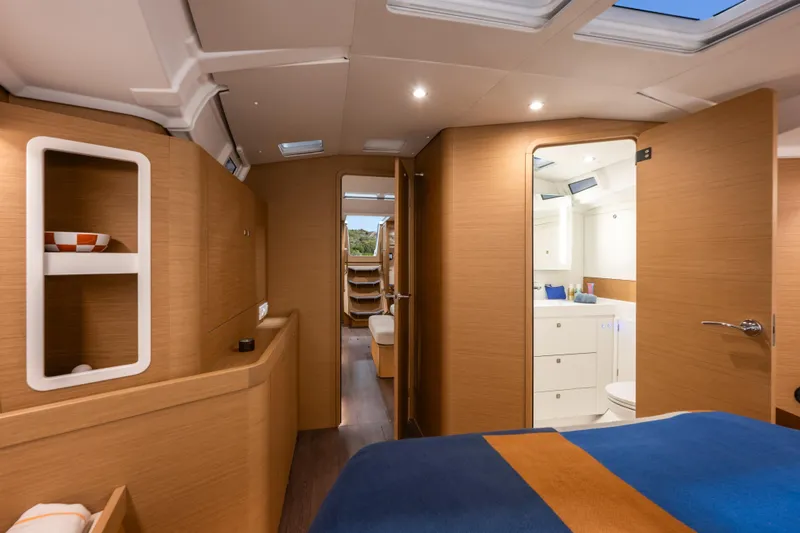  Yacht Photos Pics Luxurious interior of 2026 Jeanneau Sun Odyssey 455 yacht, featuring modern wood finishes and cozy design.