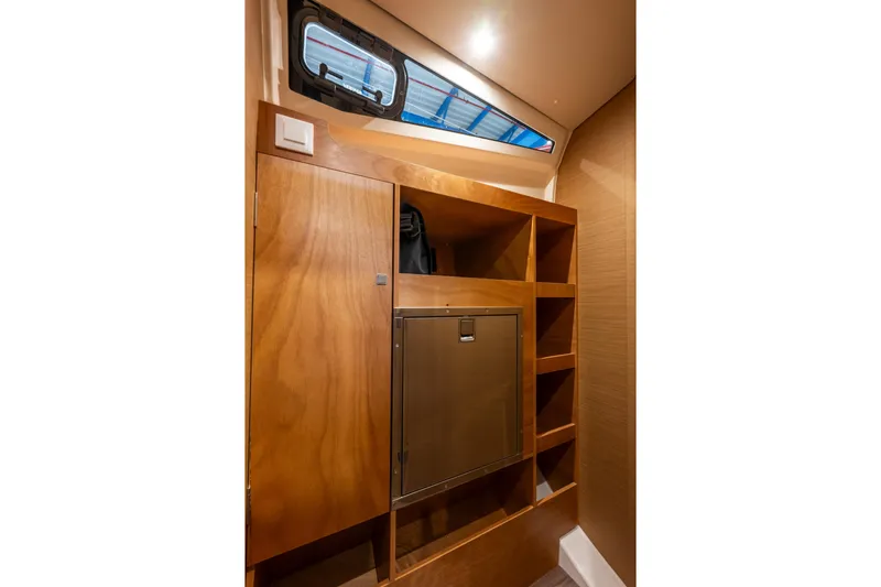  Yacht Photos Pics Interior of 2026 Jeanneau Sun Odyssey 455 yacht with wooden cabinetry and storage.