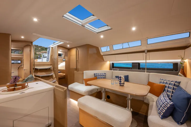  Yacht Photos Pics Luxurious interior of 2026 Jeanneau Sun Odyssey 455 yacht with modern seating and skylights.