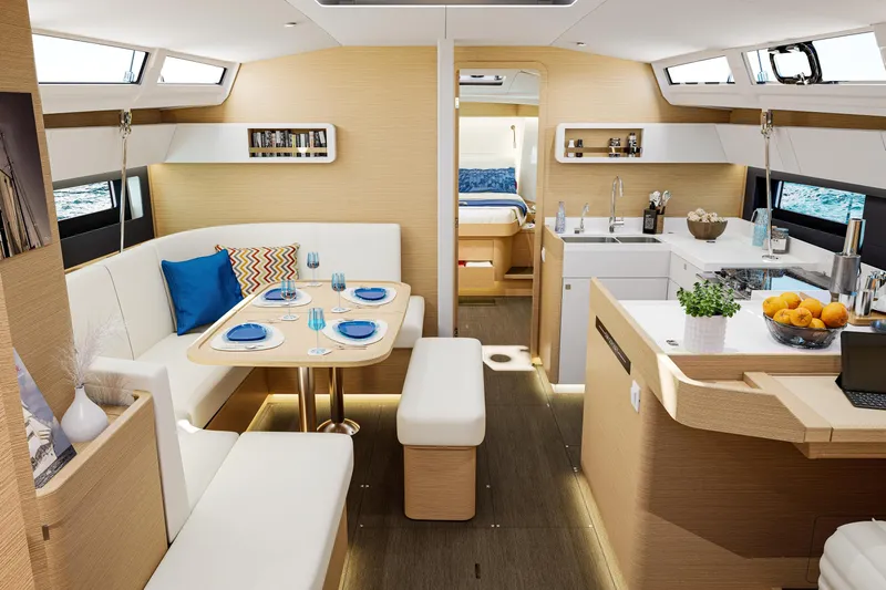  Yacht Photos Pics Luxurious interior of 2026 Jeanneau Sun Odyssey 455 yacht with modern dining and kitchen area.