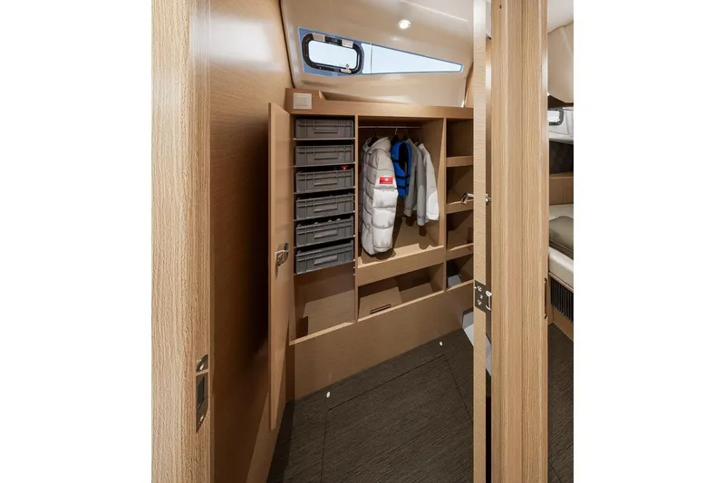  Yacht Photos Pics Interior of 2026 Jeanneau Sun Odyssey 455 yacht with wooden cabinetry and storage.