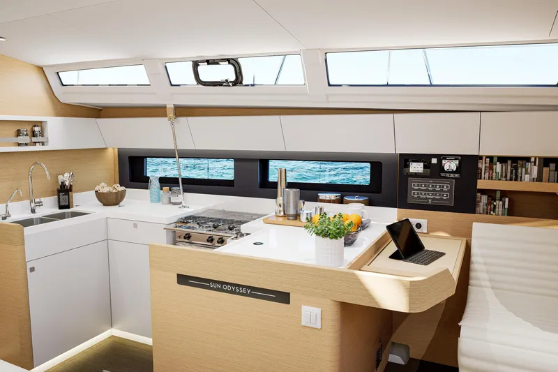  Yacht Photos Pics Modern kitchen interior of 2026 Jeanneau Sun Odyssey 455 yacht, featuring sleek design and ocean view.