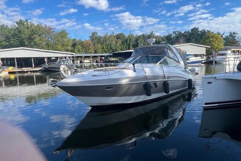  Yacht Photos Pics 2008 Cruisers Yachts 330 Express docked at a marina under a blue sky.
