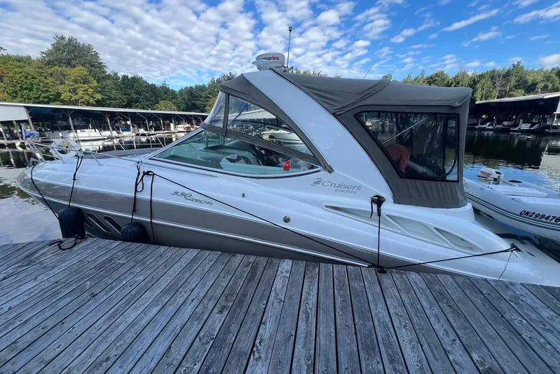  Yacht Photos Pics 2008 Cruisers Yachts 330 Express docked at a marina under a blue sky.