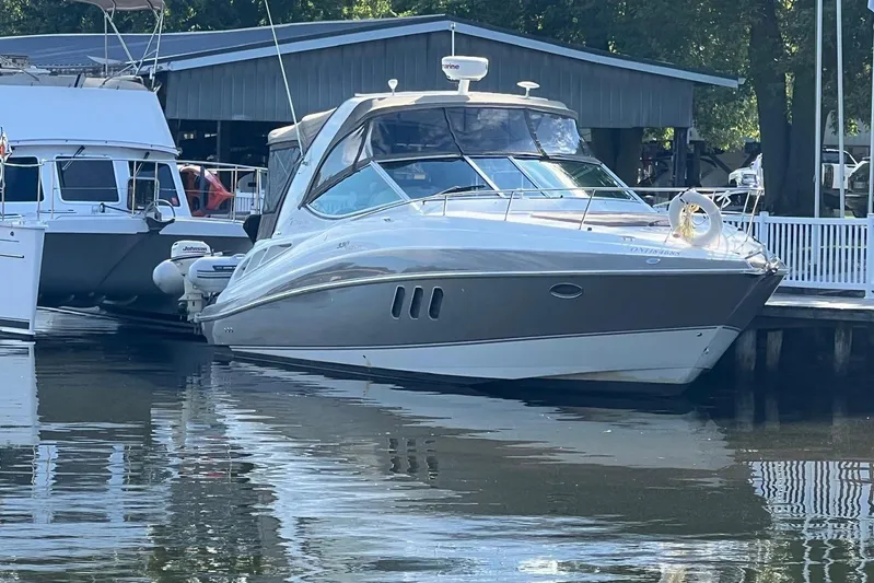  Yacht Photos Pics 2008 Cruisers Yachts 330 Express docked at marina, reflecting on calm water.