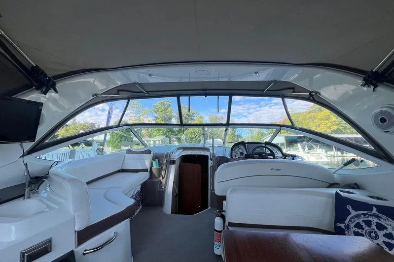  Yacht Photos Pics 2008 Cruisers Yachts 330 Express interior with helm, seating, and scenic marina view.