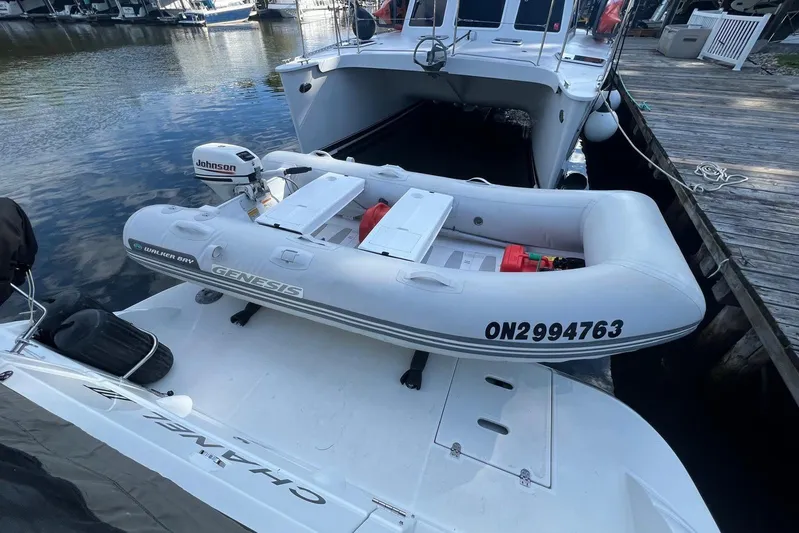  Yacht Photos Pics 2008 Cruisers Yachts 330 Express with inflatable dinghy docked by the water.