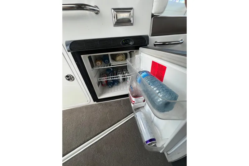  Yacht Photos Pics 2008 Cruisers Yachts 330 Express interior fridge with beverages and snacks.