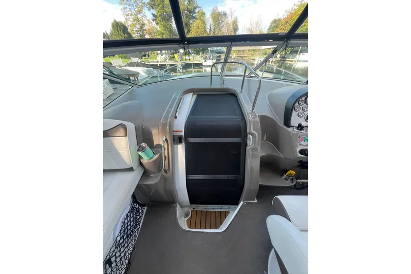  Yacht Photos Pics 2008 Cruisers Yachts 330 Express helm with dashboard and seating, docked outdoors.