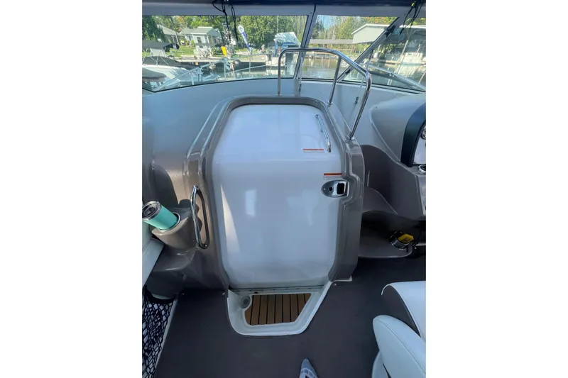  Yacht Photos Pics 2008 Cruisers Yachts 330 Express cockpit with helm and seating area, docked at marina.