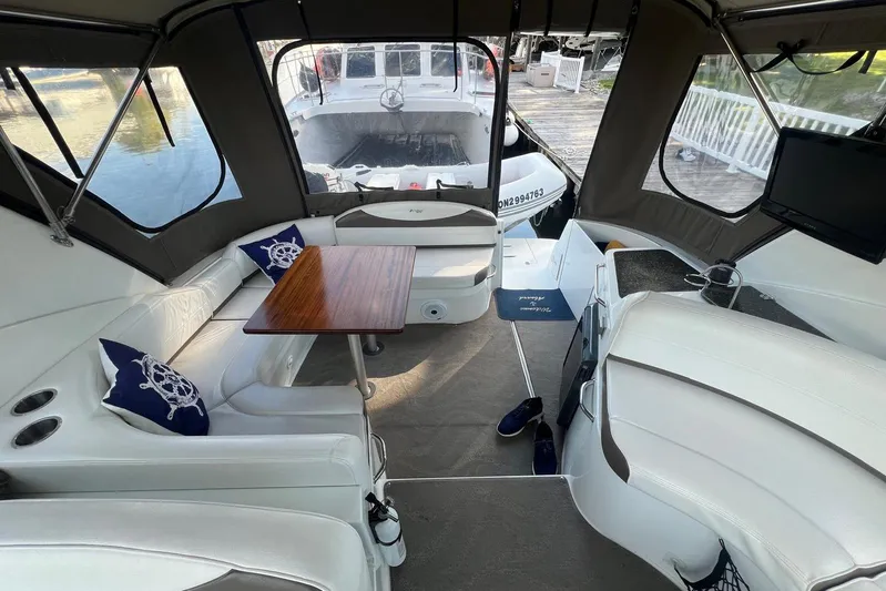  Yacht Photos Pics 2008 Cruisers Yachts 330 Express interior with seating, table, and nautical decor.