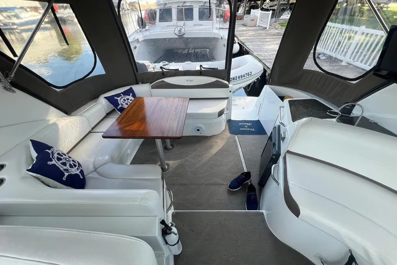  Yacht Photos Pics 2008 Cruisers Yachts 330 Express interior with seating, table, and nautical decor.