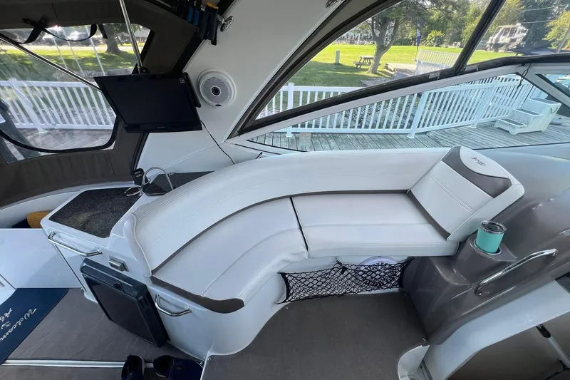  Yacht Photos Pics 2008 Cruisers Yachts 330 Express interior with white seating and mounted TV.