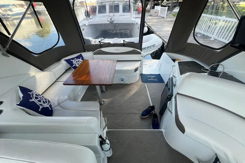  Yacht Photos Pics 2008 Cruisers Yachts 330 Express interior with seating, table, and nautical decor.
