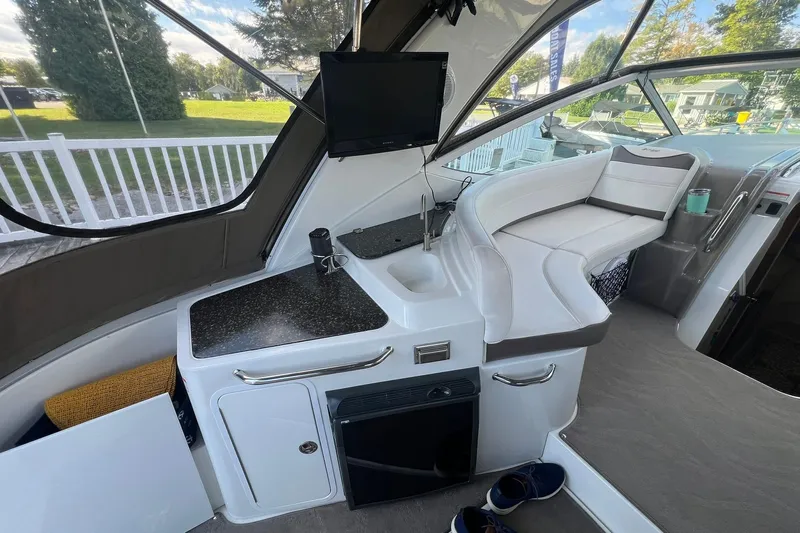  Yacht Photos Pics 2008 Cruisers Yachts 330 Express interior with seating, sink, and TV.