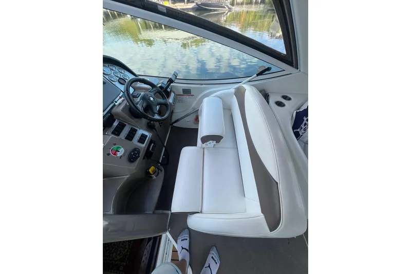  Yacht Photos Pics 2008 Cruisers Yachts 330 Express helm with white seating and steering wheel, dockside view.