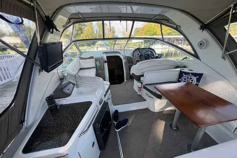  Yacht Photos Pics 2008 Cruisers Yachts 330 Express interior with kitchenette, seating, and helm, showcasing luxury design.