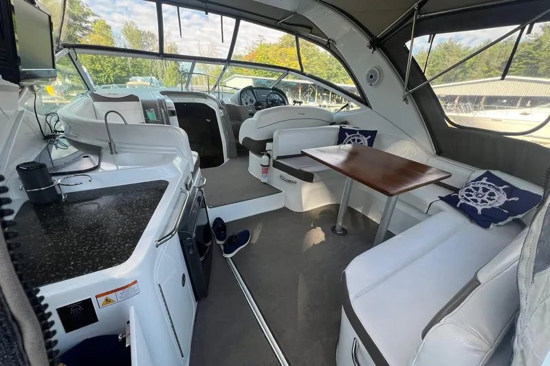  Yacht Photos Pics 2008 Cruisers Yachts 330 Express interior with kitchen, seating, and helm.