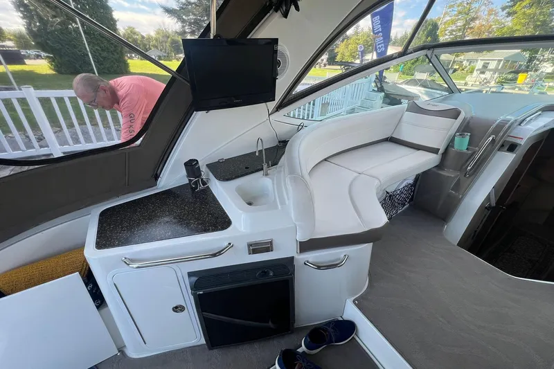  Yacht Photos Pics 2008 Cruisers Yachts 330 Express interior with seating, kitchenette, and TV.