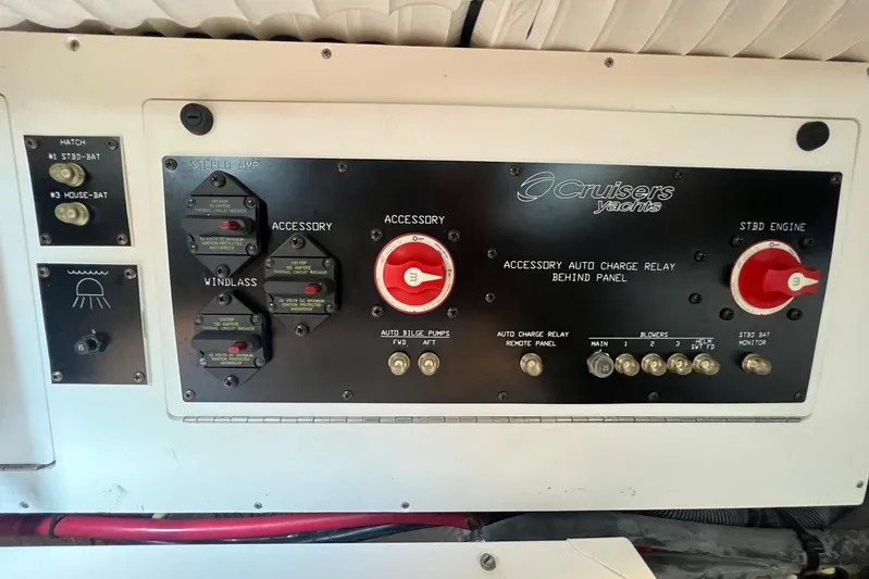  Yacht Photos Pics Control panel of a 2008 Cruisers Yachts 330 Express, featuring switches and charge relays.