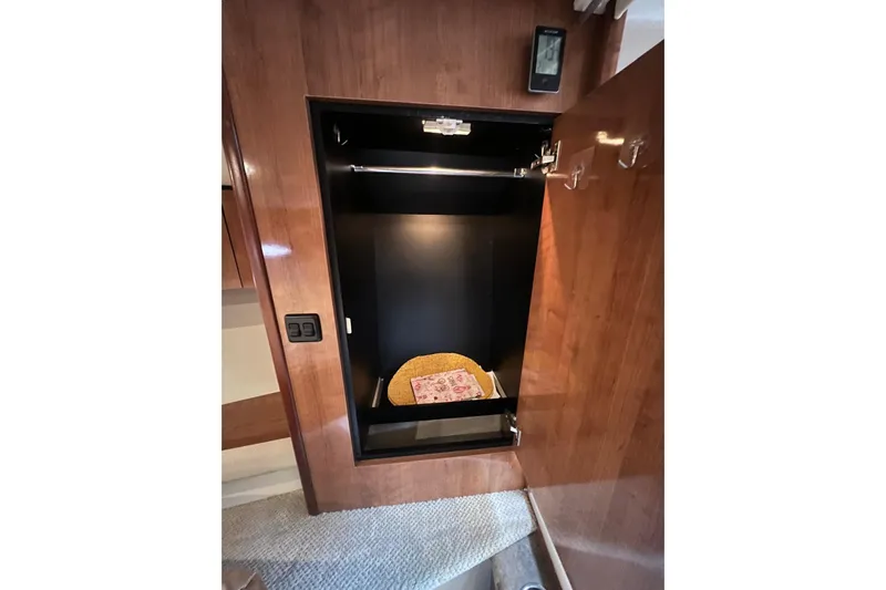  Yacht Photos Pics 2008 Cruisers Yachts 330 Express interior closet with wooden finish and storage space.
