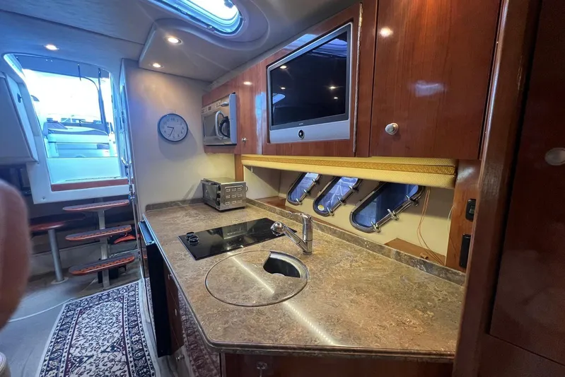  Yacht Photos Pics Luxurious 2008 Cruisers Yachts 330 Express interior kitchen with modern amenities.