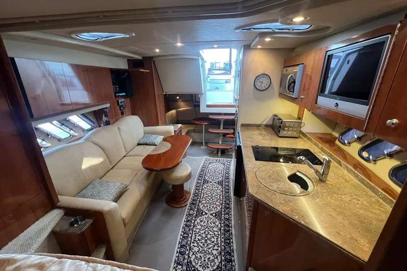  Yacht Photos Pics Interior of 2008 Cruisers Yachts 330 Express, featuring a cozy lounge and modern kitchen amenities.