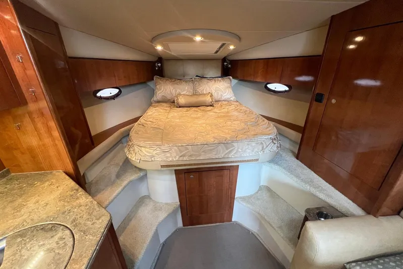  Yacht Photos Pics Luxurious cabin interior of 2008 Cruisers Yachts 330 Express with cozy bed and wood finish.