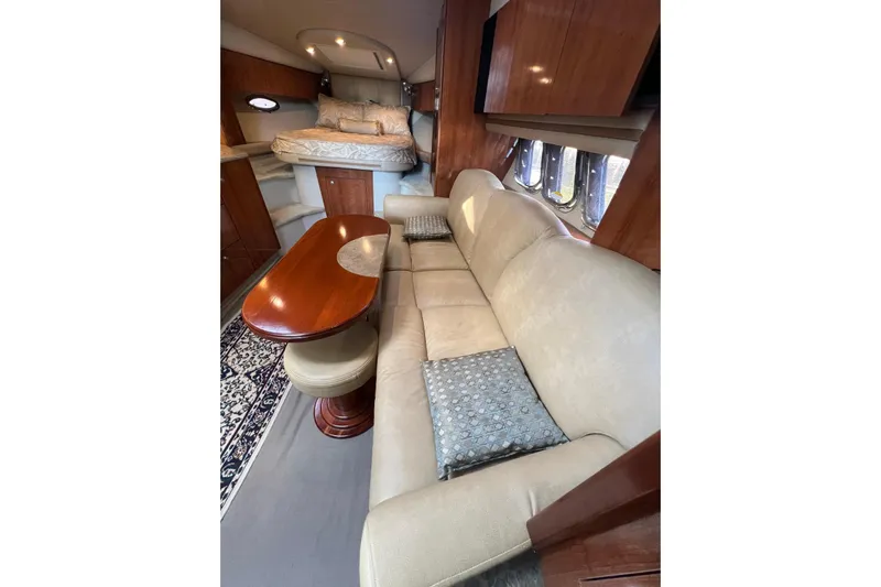  Yacht Photos Pics Interior of 2008 Cruisers Yachts 330 Express with beige seating and wooden table.