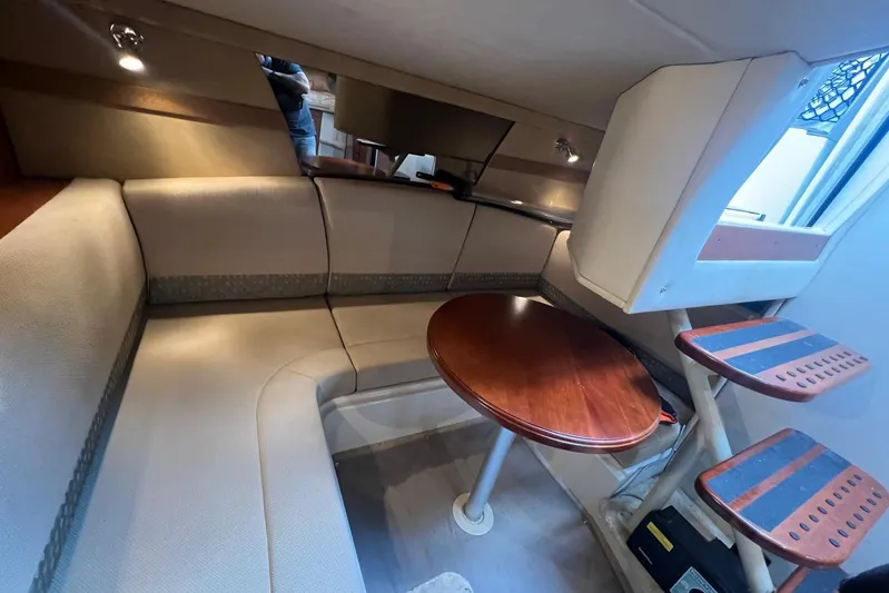  Yacht Photos Pics 2008 Cruisers Yachts 330 Express interior with cozy seating and wooden table.