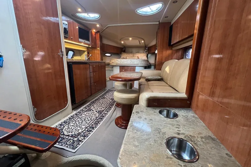  Yacht Photos Pics Luxurious 2008 Cruisers Yachts 330 Express interior with wood finishes and cozy seating area.