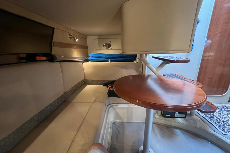  Yacht Photos Pics 2008 Cruisers Yachts 330 Express cabin interior with seating and wooden table.